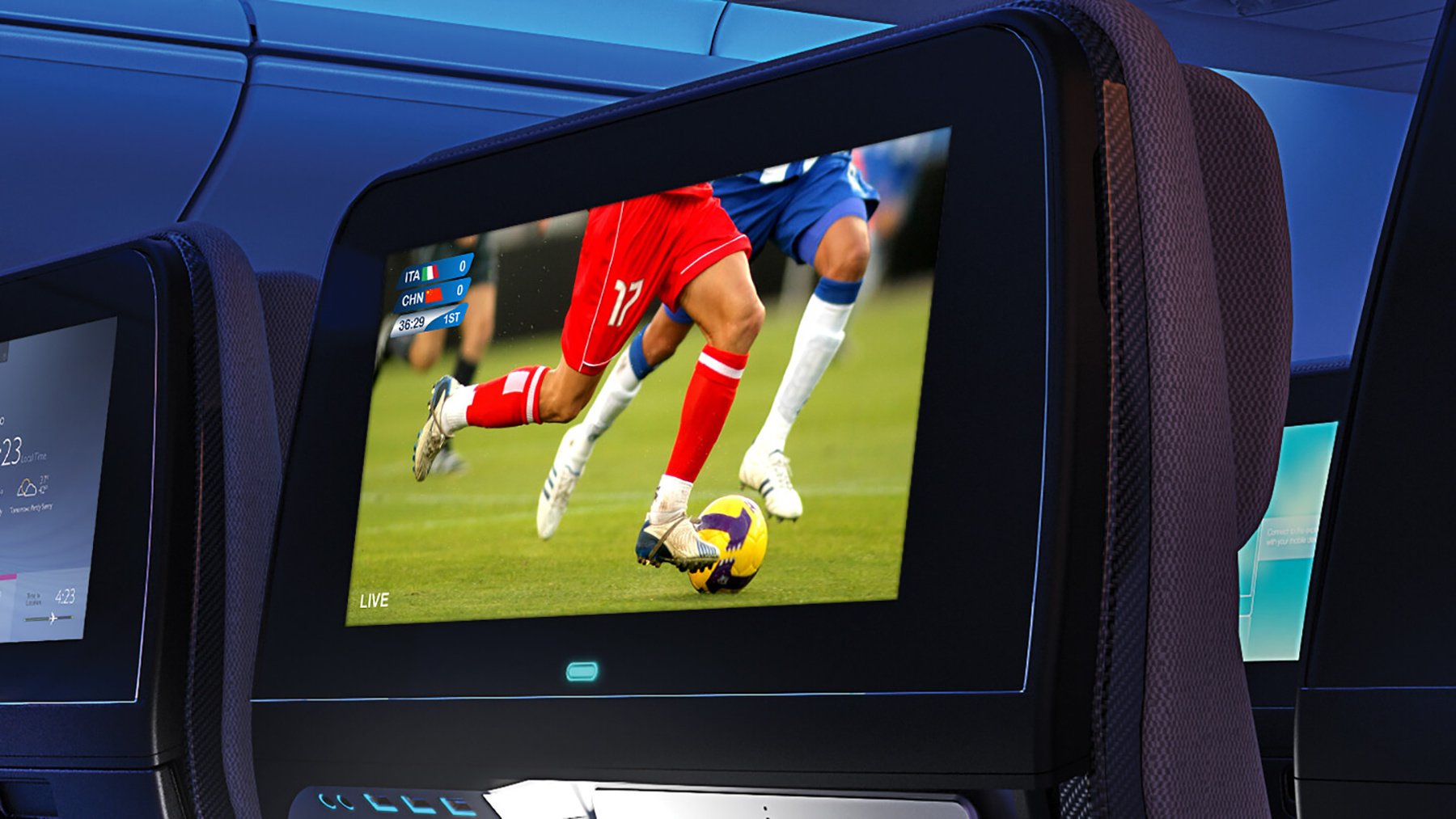 Airplane seatback screen showing a live soccer match with players in red and blue